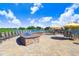 Community patio area with fire pit and seating overlooking a lake at 251 Tomelloso Way, Davenport, FL 33837