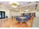 Community room with tables and chairs, hardwood floors, and modern lighting at 251 Tomelloso Way, Davenport, FL 33837