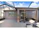 Relaxing patio with brick pavers and a shade screen at 251 Tomelloso Way, Davenport, FL 33837