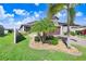 Well-maintained front yard with palm trees and landscaping at 251 Tomelloso Way, Davenport, FL 33837