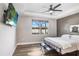 Primary bedroom with ceiling fan, large TV, and ensuite bathroom access at 251 Tomelloso Way, Davenport, FL 33837