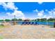 Lakefront patio with lounge chairs, offering a peaceful lakeside view at 251 Tomelloso Way, Davenport, FL 33837