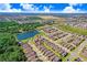 Aerial view of a house in a residential neighborhood with a lake nearby at 251 Tomelloso Way, Davenport, FL 33837