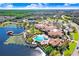 Aerial view of community with clubhouse, pool, and lake at 251 Tomelloso Way, Davenport, FL 33837