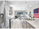 Modern kitchen with granite countertops, stainless steel appliances, and large island at 251 Tomelloso Way, Davenport, FL 33837