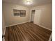 Bright bedroom with wood-look flooring and a large closet at 3414 Portersfield Rd, Orlando, FL 32808