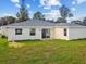 Back of the house with sliding glass doors and a large yard at 2511 Avenue E Sw, Winter Haven, FL 33880