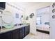 Double vanity bathroom with a view of bedroom at 612 Chicago Way, Dundee, FL 33838