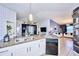 Open kitchen with island, stainless steel appliances, and granite countertops at 612 Chicago Way, Dundee, FL 33838