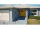 House entrance with yellow door and sunflower decor at 612 Chicago Way, Dundee, FL 33838