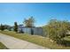 Side yard with wooden fence and landscaping at 612 Chicago Way, Dundee, FL 33838