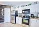 Modern kitchen with stainless steel appliances and white shaker cabinets at 612 Chicago Way, Dundee, FL 33838