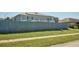 House back view, featuring solar panels and wooden fence at 612 Chicago Way, Dundee, FL 33838