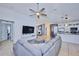 Open concept living area showcasing a gray sectional sofa and views into the kitchen at 612 Chicago Way, Dundee, FL 33838