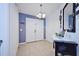 Bright entryway with double doors, decorative console table and mirror at 612 Chicago Way, Dundee, FL 33838