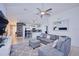 Spacious living area with L-shaped sectional sofa and a view into the kitchen at 612 Chicago Way, Dundee, FL 33838