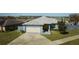 One-story house with attached garage and landscaped yard at 612 Chicago Way, Dundee, FL 33838