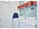Bright laundry room with washer, dryer and storage at 612 Chicago Way, Dundee, FL 33838
