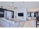 Open living area with gray sectional sofa, mounted TV, and decorative wall features at 612 Chicago Way, Dundee, FL 33838