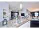 Open kitchen with island, stainless steel appliances, and granite countertops at 612 Chicago Way, Dundee, FL 33838