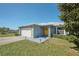 One-story house with yellow door and landscaped yard at 612 Chicago Way, Dundee, FL 33838