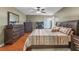 Main bedroom with king size bed, dresser, and ensuite bathroom at 4615 Cumbrian Lakes Dr, Kissimmee, FL 34746