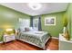 Bedroom with a queen bed, leafy bedding, and wood floors at 4615 Cumbrian Lakes Dr, Kissimmee, FL 34746