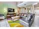 Open living area with sectional sofa, large TV, and decorative wall at 4615 Cumbrian Lakes Dr, Kissimmee, FL 34746