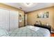 Bedroom with a queen bed, leafy bedding, and wood floors at 4615 Cumbrian Lakes Dr, Kissimmee, FL 34746