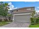 Beige two-story house with a brown roof and a two-car garage at 4615 Cumbrian Lakes Dr, Kissimmee, FL 34746