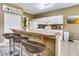 Eat-in kitchen with white cabinets, breakfast bar, and tile floors at 4615 Cumbrian Lakes Dr, Kissimmee, FL 34746