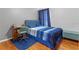 Bedroom with a full-size bed, blue bedding, and wood floors at 4615 Cumbrian Lakes Dr, Kissimmee, FL 34746