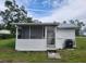 White cottage with screened porch at 1058 N Davis Ave, Lakeland, FL 33805