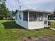 White cottage with screened porch at 1058 N Davis Ave, Lakeland, FL 33805