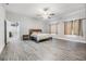 Bright bedroom featuring a walk-in closet and ceiling fan at 2305 Flaming Arrow Dr, Lakeland, FL 33813