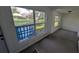 Sunroom with tiled floor and large windows offering natural light at 1049 Edith Ave, Lakeland, FL 33805