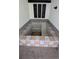 Built-in hot tub with tiled surround and seating area at 1049 Edith Ave, Lakeland, FL 33805