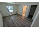 Bright bedroom with wood-look floors and an ensuite bathroom at 1049 Edith Ave, Lakeland, FL 33805