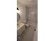 Bathroom with marble shower/tub combo, white vanity and flooring at 1049 Edith Ave, Lakeland, FL 33805