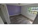 Spacious bedroom with light purple accent wall and wood-look floors at 1049 Edith Ave, Lakeland, FL 33805