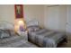 Spacious bedroom with twin beds, a nightstand, and ample closet space at 511 Rum Run # 33511, Davenport, FL 33897