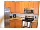 Well-equipped kitchen with stainless steel appliances and wood cabinets at 511 Rum Run # 33511, Davenport, FL 33897