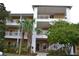 Two-story condo building with palm trees and lush landscaping at 511 Rum Run # 33511, Davenport, FL 33897
