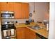 Corner kitchen with stainless steel appliances and wood cabinets at 511 Rum Run # 33511, Davenport, FL 33897