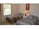 Two twin beds in a bright bedroom with large window and white wicker furniture at 511 Rum Run # 33511, Davenport, FL 33897