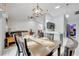 Bright dining room with a wooden table, four chairs, and a view into the living room at 7764 Indian Ridge N Trl, Kissimmee, FL 34747