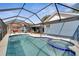 Inviting pool area with spa and screened enclosure, perfect for relaxation at 7764 Indian Ridge N Trl, Kissimmee, FL 34747