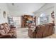 Bright living room with large TV, comfortable seating, and hardwood floors at 163 Andalusia Loop, Davenport, FL 33837