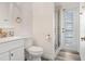 Guest bathroom with toilet, sink, and walk-in shower at 163 Andalusia Loop, Davenport, FL 33837