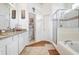 Bathroom with double vanity, soaking tub, and walk-in shower at 163 Andalusia Loop, Davenport, FL 33837